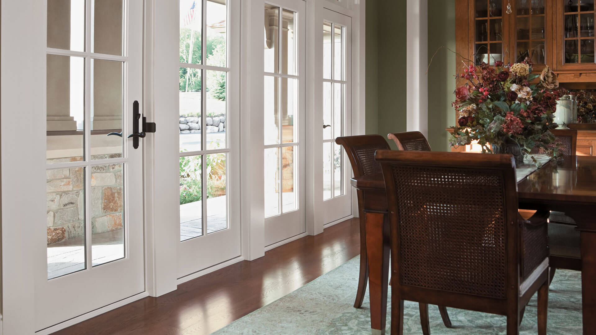 Dining room featuring a pair of white-frame Frenchwood patio doors.