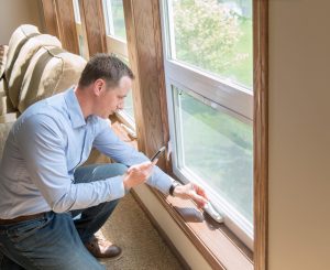 man installing energy efficient replacement windows