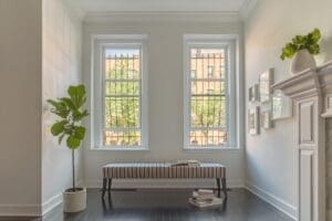 Casual sitting area with two windows overlooking the city