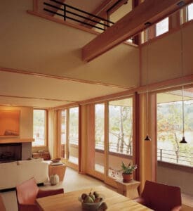 Modern home with high ceiling loft and wood accents with wood framed sliding patio door on first floor