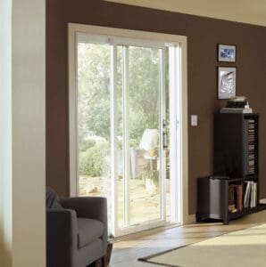 Close up of simple sliding glass patio door against a dark wall in a modest living room