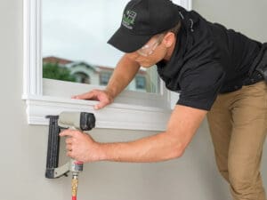 man repairing window seal failure